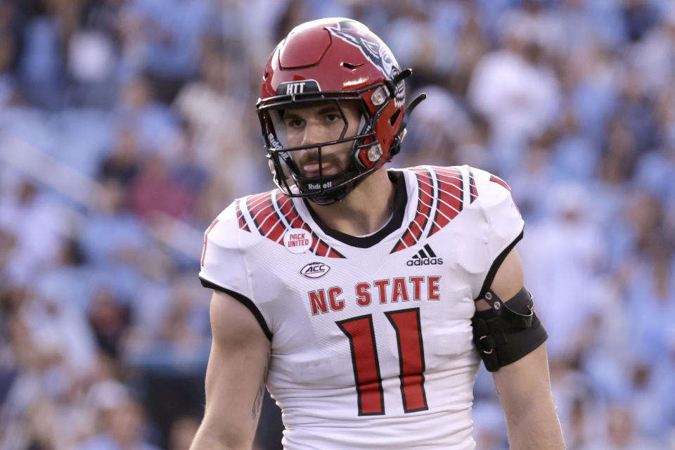 FILE - North Carolina State linebacker Payton Wilson (11) lines up on defense during the first half of an NCAA college football game against North Carolina, Nov. 25, 2022, in Chapel Hill, N.C. N.C. State opens the season at Connecticut on Aug. 31, 2023. (AP Photo/Chris Seward, File)