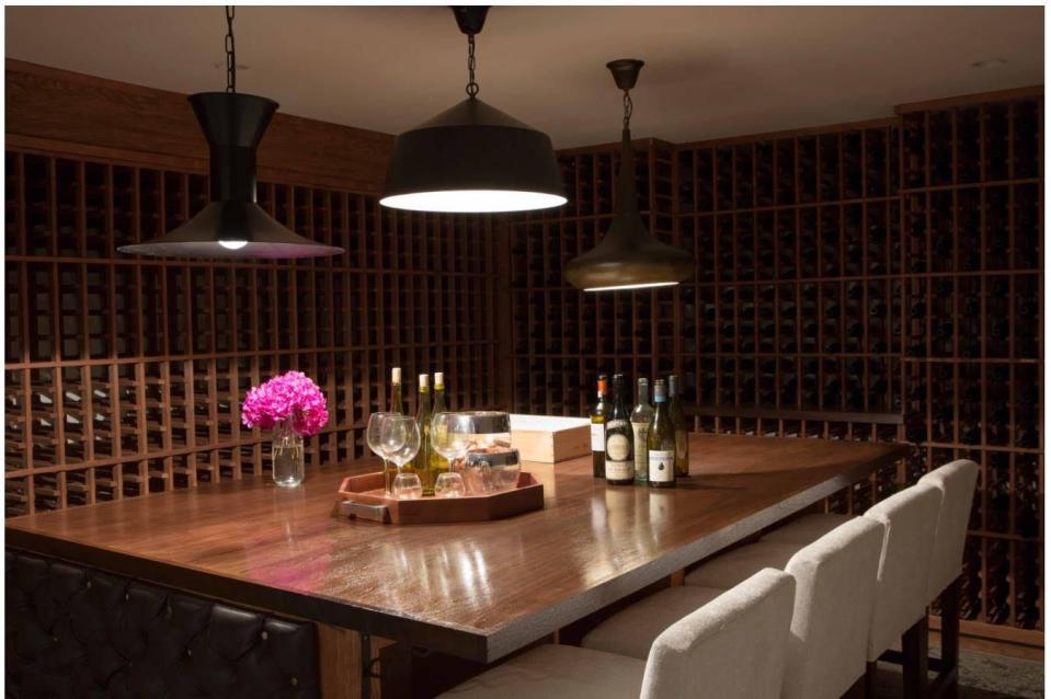 <p>By nature, wine cellars belong underground where it's cooler. If you have a basement, take advantage of the natural climate and build yourself your dream wine cellar. You'll get bonus points for adding a table for tastings, as in this space by Kishani Perera.</p>