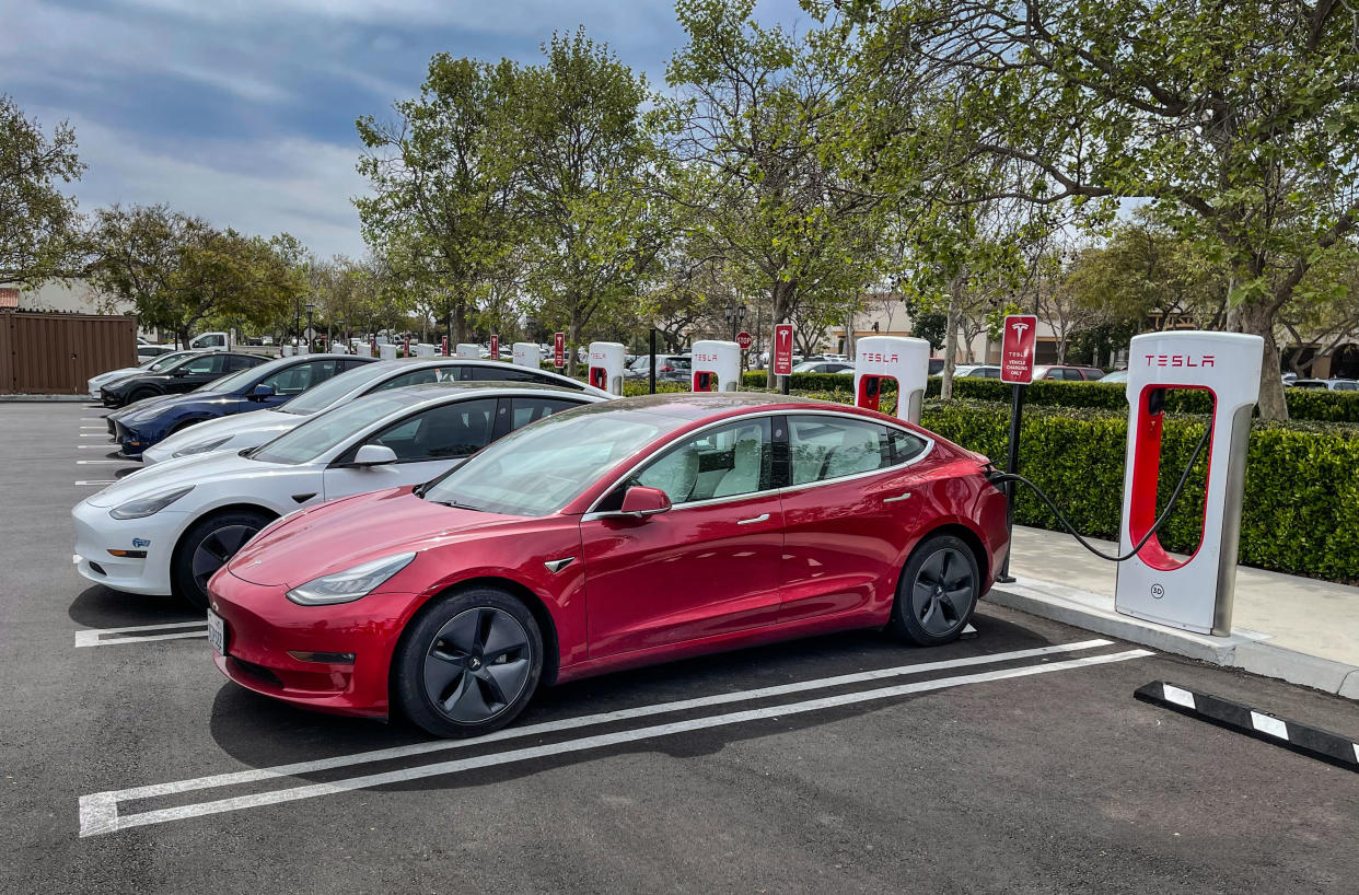 GOLETA, CA - MARCH 18:  A number of Tesla electric vehicles are lined up and charging their EV batteries in this outdoor public charging station just north of Santa Barbara on March 18, 2022, in Goleta, California. Because of its close proximity to Southern California and Los Angeles population centers, the coastal communities of Santa Barbara County have become a popular weekend getaway destination for millions of tourists each year. (Photo by George Rose/Getty Images)