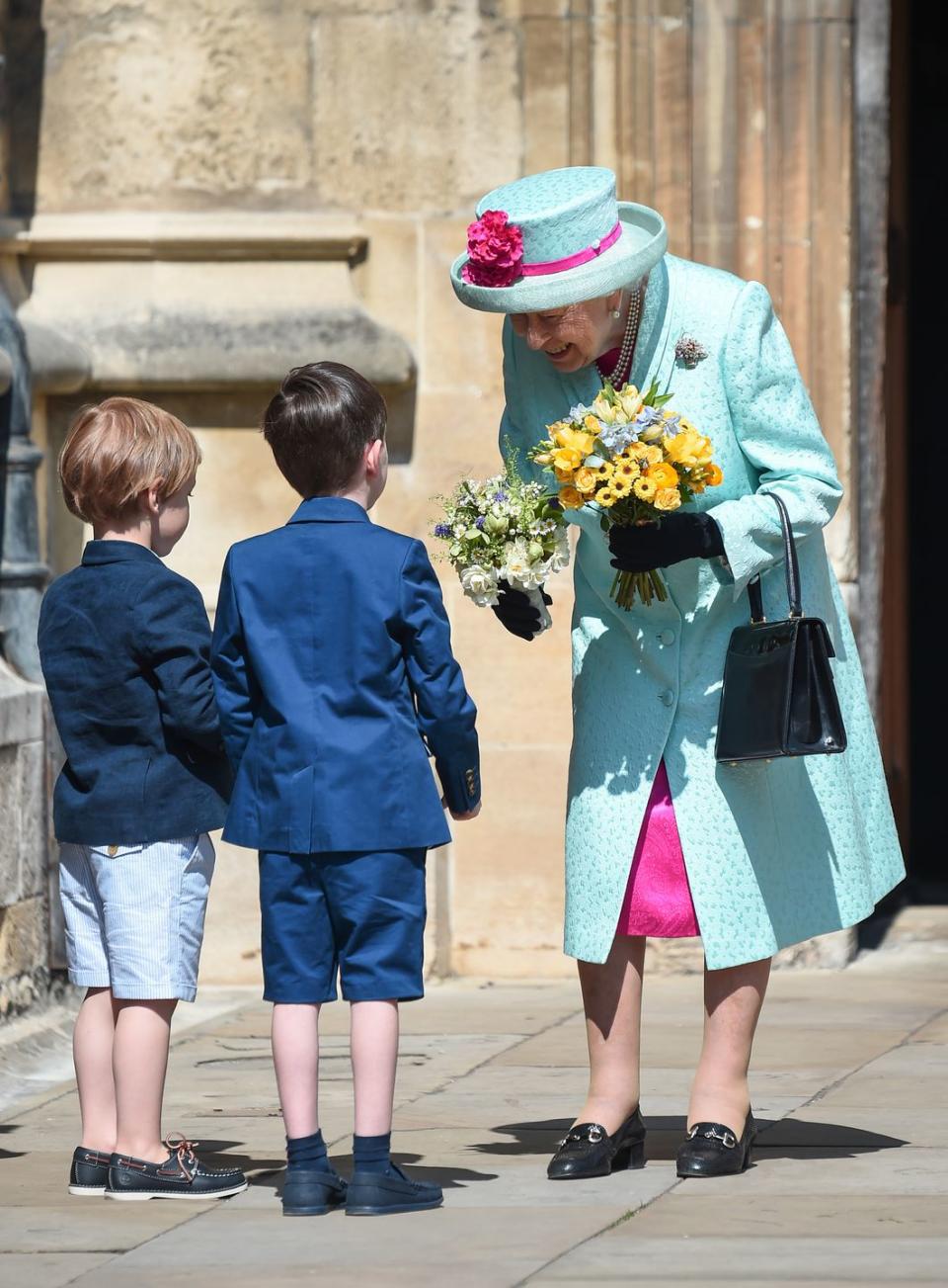 Queen Elizabeth receives flowers.