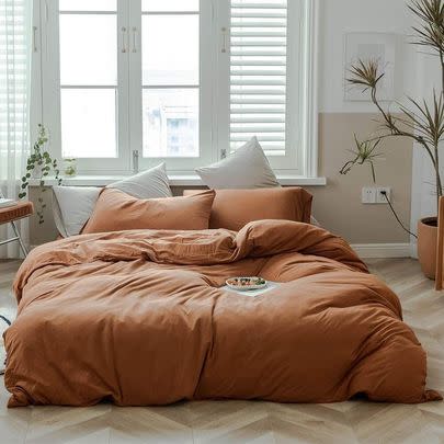 A cotton knit duvet cover in pumpkin so you can make your bedroom look like a chic autumn dream even if you only sloppily make the bed