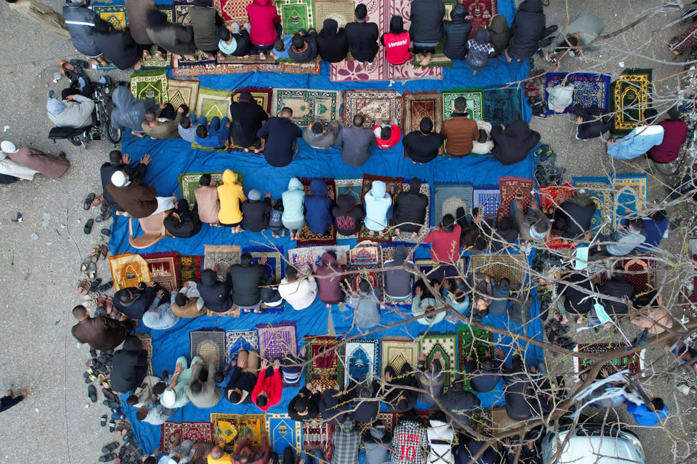 A drone view shows Palestinians holding Eid al-Fitr prayers by the ruins of al-Farouk mosque, amid the ongoing conflict between Israel and Palestinian Islamist group Hamas, in Rafah, in the southern Gaza Strip on 10 April 2024