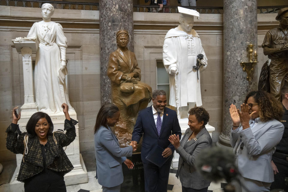Sen. Laphonza Butler, D-Calif., second from left, reacts after being sworn into the Congressional Black Caucus by Rep. Steven Horsford, D-Nev., third from left, in front of a statue of Rosa Parks in the Hall of Statuary on Capitol Hill, Tuesday, Oct. 3, 2023 in Washington. (AP Photo/Mark Schiefelbein)