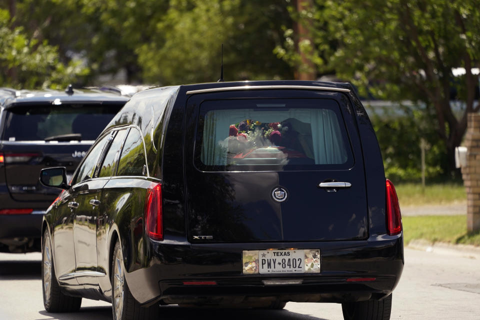 A hearse with the casket of Jacklyn Cazares passes through town following a funeral service at Sacred Heart Catholic Church, Friday, June 3, 2022, in Uvalde, Texas. Cazares was killed in last week's elementary school shooting. (AP Photo/Eric Gay)