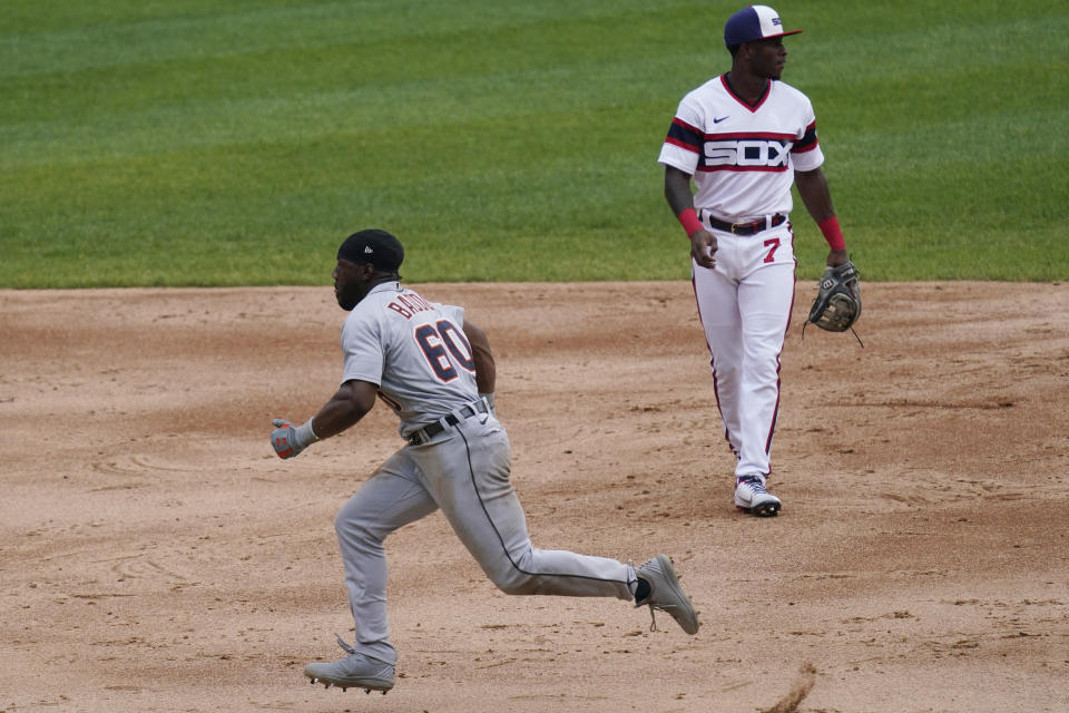 Detroit Tigers' Akil Baddoo, left, runs to third after stealing second base after Chicago White Sox second baseman Nick Madrigal could not make the play on a throwing error by catcher Yasmani Grandal as White Sox shortstop Tim Anderson looks on during the third inning of a baseball game in Chicago, Sunday, June 6, 2021. (AP Photo/Nam Y. Huh)