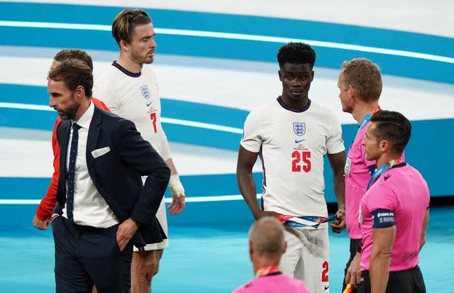 England players and staff stand dejected after full-time in the Euro 2020 final