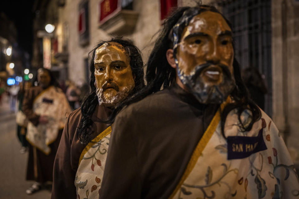 Members of the "Penitencia de los Apóstoles y Discípulos de Jesús" Catholic brotherhood during a Holy Week procession in the southern city of Alcala la Real, Spain, Thursday, March 28, 2024. (AP Photo/Bernat Armangue)