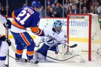 May 6, 2016; Brooklyn, NY, USA; Tampa Bay Lightning goalie Ben Bishop (30) makes a save against New York Islanders right wing Kyle Okposo (21) during the second period of game four of the second round of the 2016 Stanley Cup Playoffs at Barclays Center. Mandatory Credit: Brad Penner-USA TODAY Sports
