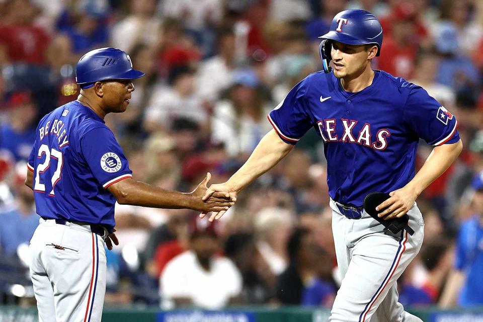 <p>Tim Nwachukwu/Getty </p> Corey Seager rounds the base after hitting a home run into a Phillies fan