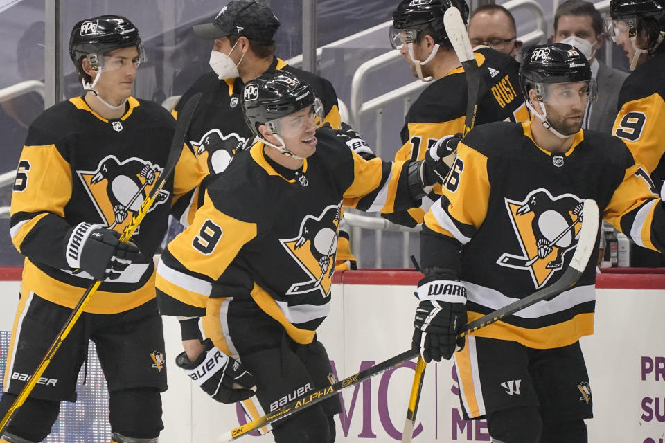 Pittsburgh Penguins' Evan Rodrigues (9) returns to the bench after scoring during the second period of an NHL hockey game against the New Jersey Devils in Pittsburgh, Tuesday, April 20, 2021. (AP Photo/Gene J. Puskar)