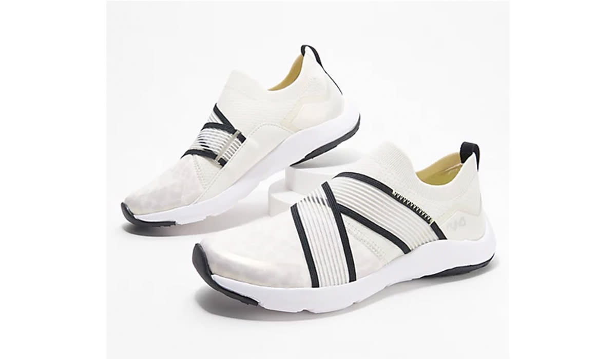 White slip-on sneakers with black accents