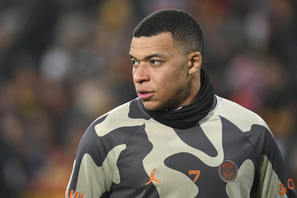 PSG's Kylian Mbappe warms up prior to the French League One soccer match between Lens and Paris Saint-Germain at the Bollaert-Delelis stadium in Lens, northern France, Sunday, Jan. 14, 2024. (AP Photo/ Matthieu Mirville)