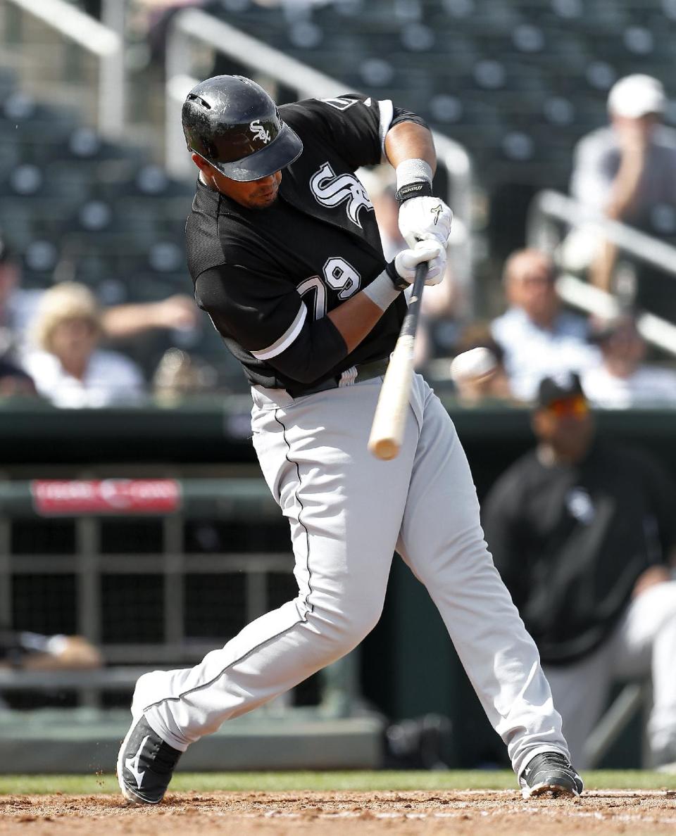 Chicago White Sox's Jose Abreu hits a two-run double against the Cleveland Indians during an exhibition baseball game in Goodyear, Ariz., Tuesday, March 4, 2014. (AP Photo/Paul Sancya)