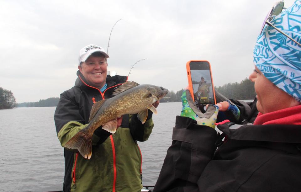Rikki Pardun takes a photo of Barb Carey with a 22-inch walleye Carey caught in the 2023 Governor's Fishing Opener in Wisconsin.