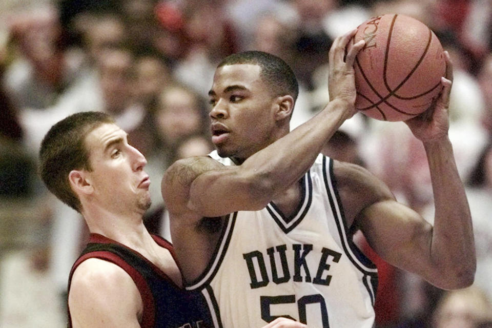 Duke's Corey Maggette (50) drives past Temple's Pepe Sanchez during the first half of the East Regional final, Sunday March 21, 1999, in East Rutherford, N.J. Duke associate head coach Chris Carrawell started for a top-ranked Duke team that blew out just about every opponent behind a roster stocked with NBA talent, including a freshman reserve capable of flashing high-flying potential in limited minutes. Back then, the norm would’ve been for Maggette to return for a starring role on a title contender. Instead he became the Blue Devils’ first one-and-done NBA player in 1999. (AP Photo/Kathy Willens, File)