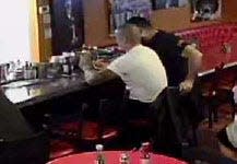 In an image obtained from surveillance video, deputy Joey Cruz (left) shared images on his phone with a bartender at a bar near Los Angeles, according to court filings. Court records state the images were of victims' remains after a helicopter crash that killed Kobe Bryant and eight others last year.