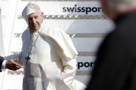 A gust of win blows Pope Francis' cape as he arrives at Dublin international airport , Ireland, Saturday, Aug. 25, 2018. Pope Francis is on a two-day visit to Ireland. (AP Photo/Greorio Borgia)