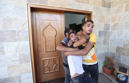 A relative of Palestinians who were killed at the Israel-Gaza border, reacts in the southern Gaza Strip September 18, 2018. REUTERS/Ibraheem Abu Mustafa