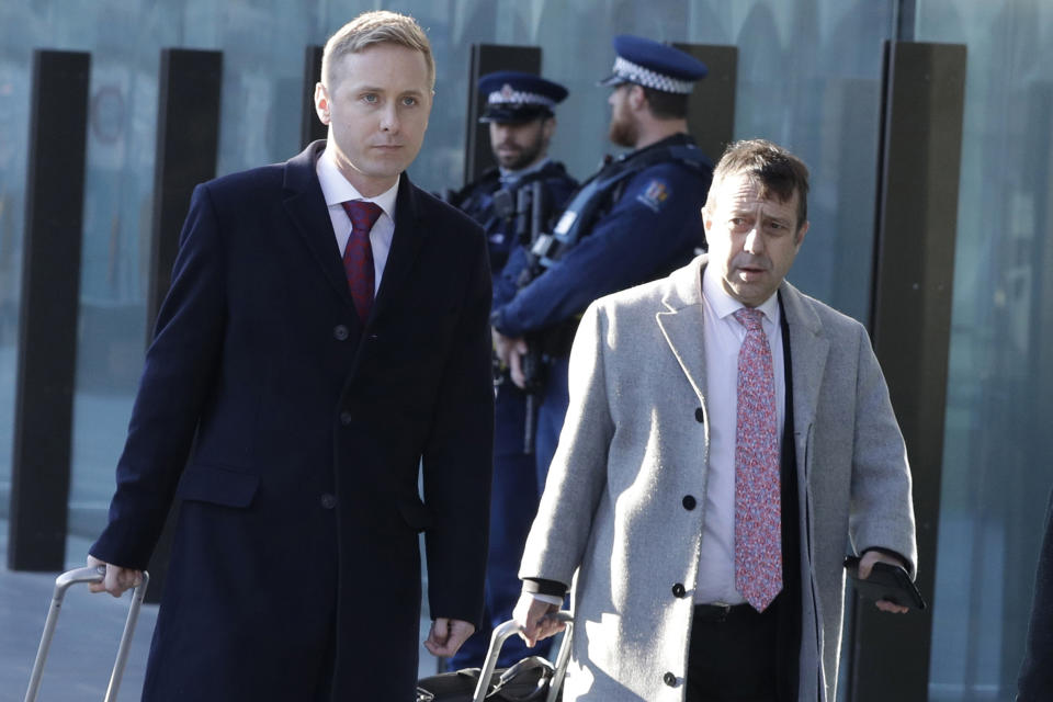 FILE - In this Aug. 15, 2019, file photo, Jonathan Hudson, left, and Shane Tait, defense lawyers for Brenton Tarrant, arrive at the Christchurch District Court in Christchurch, New Zealand. Tarrant who has admitting killing 51 worshippers in a mass shooting at two mosques in Christchurch on March 15, 2019 has dismissed his legal team and will represent himself at a sentencing hearing next month. Tarrant’s sentencing hearing, delayed by the coronavirus pandemic, will begin in Christchurch on Aug. 24, 2020 and could last more than three days. (AP Photo/Mark Baker, File)