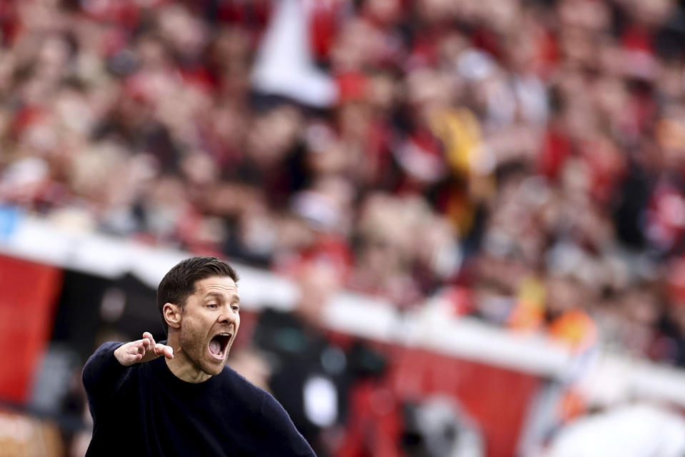 Leverkusen coach Xabi Alonso gives instructions during the Bundesliga soccer match between Bayer Leverkusen and Werder Bremen at the BayArena in Leverkusen, Germany, Sunday April 14, 2024. (Rolf Vennenbernd/dpa via AP)