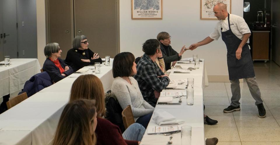 Pastry chef Josh Johnson hands Jean Towell Gebhard tempered chocolate on  Jan. 10 at Troquet in Wauwatosa. The class consisted of a multicourse dinner with wine pairings during the demonstrations by Johnson.