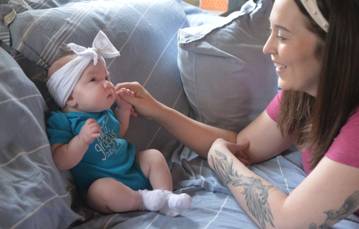 Maria Hodapp, 33. plays with her infant daughter Lorelai Edwards at their home in North East Township on April 12. Both mother and daughter are doing well after each faced life-threatening complications during the delivery.