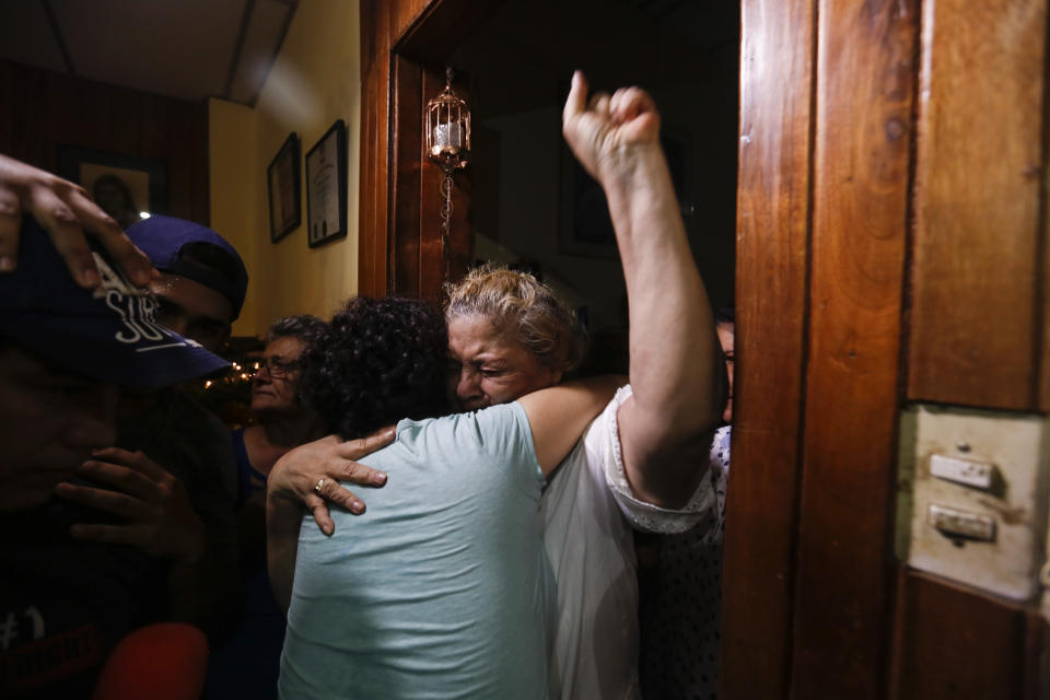 Opposition member María Adilia Peralta Cerratos is embraced by her mother Mariela Cerratos, right, during her return home after being in prison, in Masaya, Nicaragua, Monday, May 20, 2019. Peralta Cerratos is one of 100 prisoners the Nicaraguan government released Monday in a form of house arrest, including three human rights activists. (AP Photo/Alfredo Zuniga)