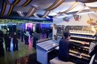 A musician plays on keyboards as retirees dance at a 'colatec' in Seoul