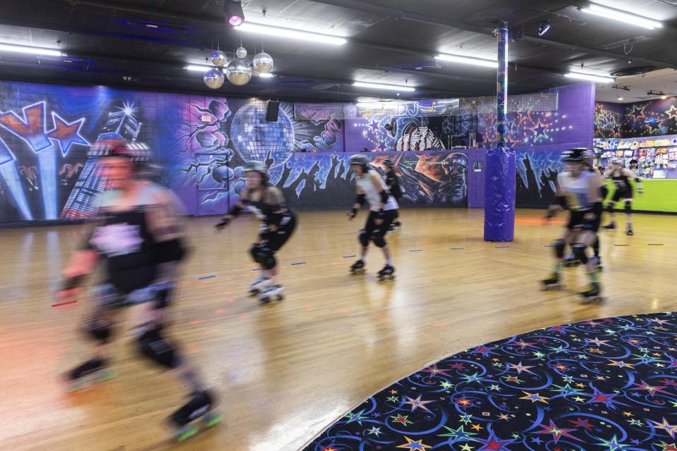 FILE - Members of the Long Island Roller Rebels, warm up before a practice, Tuesday, March 19, 2023, at United Skates of America in Seaford, N.Y. (AP Photo/Jeenah Moon, File)
