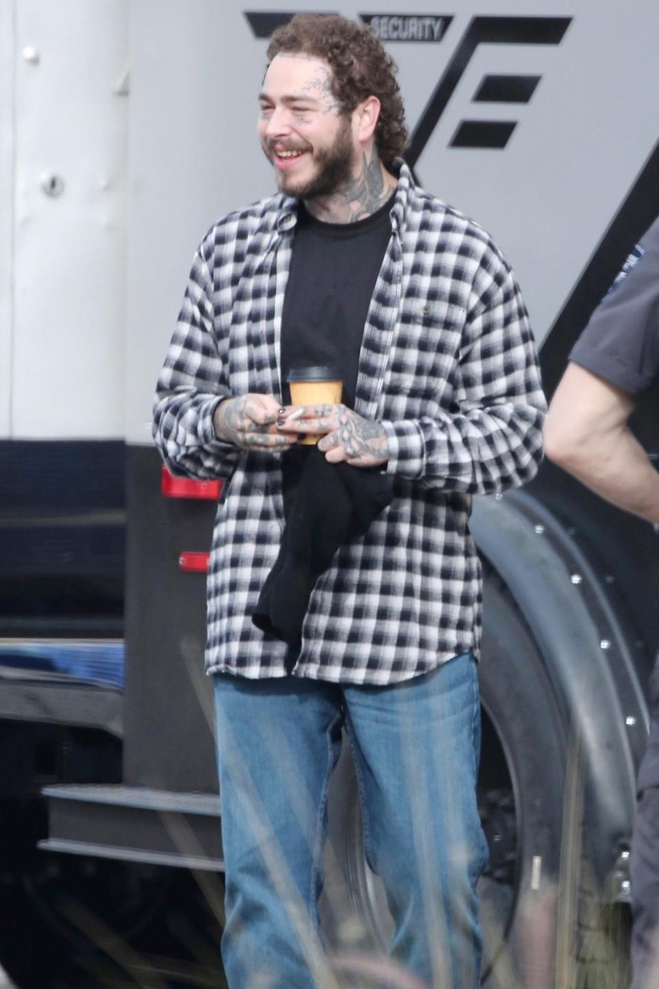 Post Malone takes a break while shooting the Guy Ritchie film <i>Cash Truck </i>— his film debut! — in L.A. on Wednesday. 