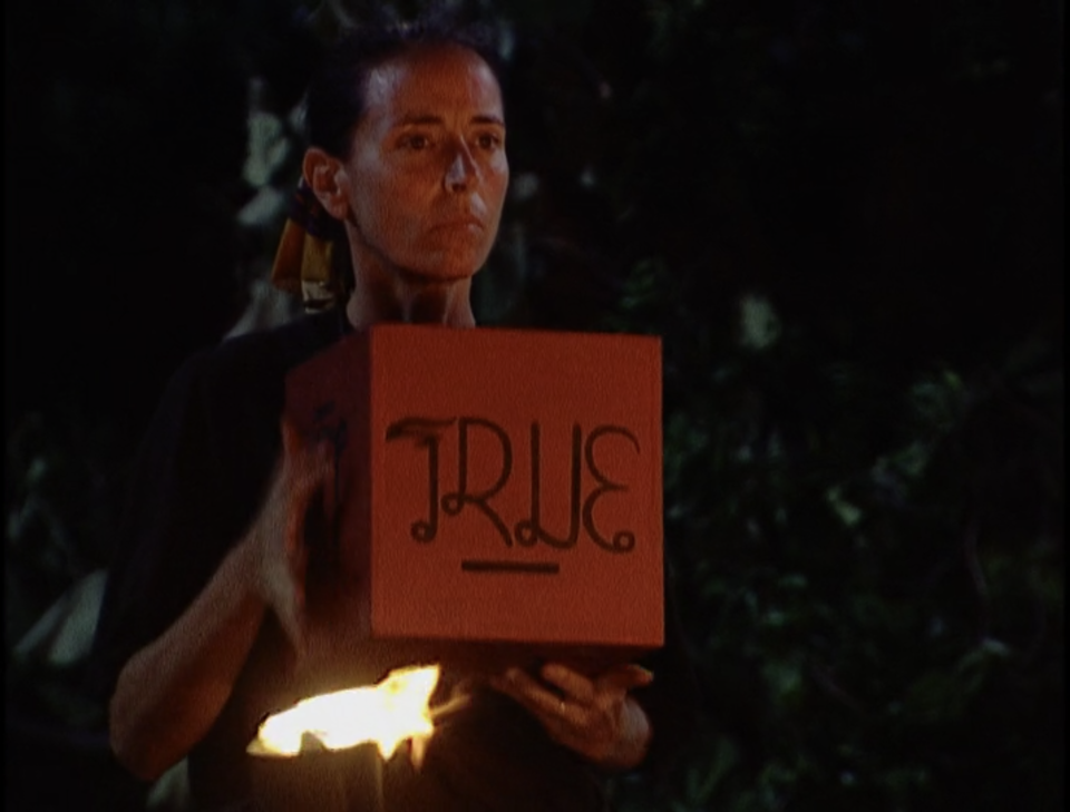 Helen Glover holds a box that says "True" on Survivor: Thailand