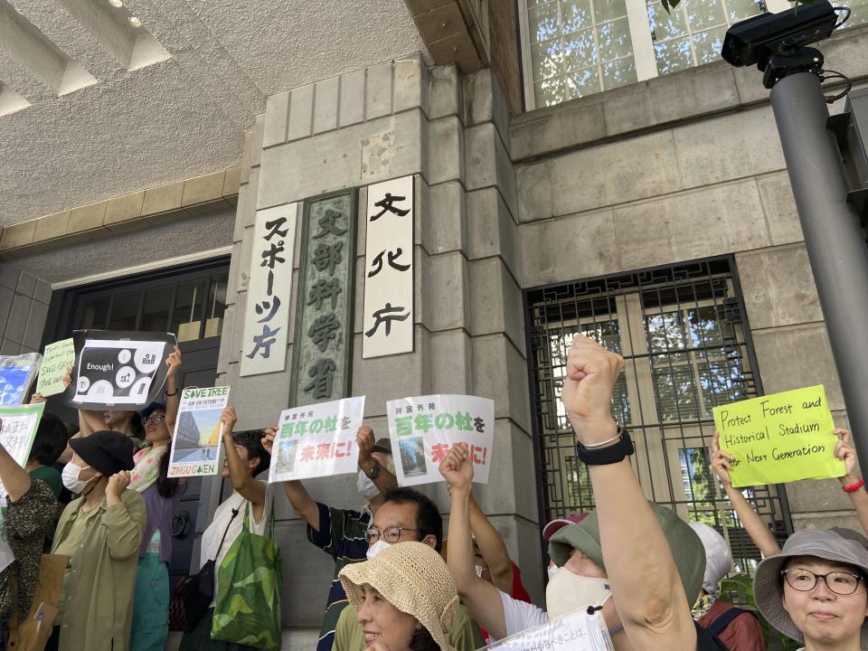 FILE - People gather outside of the Ministry of Education, Culture, Sports, Science and Technology demanding it scrap a controversial redevelopment of Tokyo's beloved Jingu Gaien park area, part of whose land is owned by an independent sports promotion unit overseen by the ministry, in Tokyo, Japan, on Sunday, Sept. 17, 2023. The Japanese bar association is urging Tokyo's metropolitan government to suspend a disputed redevelopment of the city's beloved park area, saying that its environmental assessment by developers lacked objective and scientific grounds. (AP Photo/Mari Yamaguchi, File)