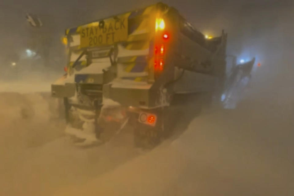 High winds and snow covers the streets and vehicles in Buffalo, N.Y. early Sunday, Dec. 25, 2022. Millions of people hunkered down in a deep freeze overnight and early morning to ride out the frigid storm that has killed at least 20 people across the United States, trapping some residents inside homes with heaping snow drifts and knocking out power to several hundred thousand homes and businesses.(WKBW via AP)