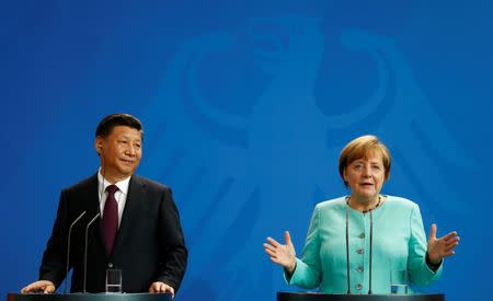 German Chancellor Angela Merkel and Chinese President Xi Jinping attend a news conference at the Chancellery in Berlin, Germany, July 5, 2017. REUTERS/Fabrizio Bensch