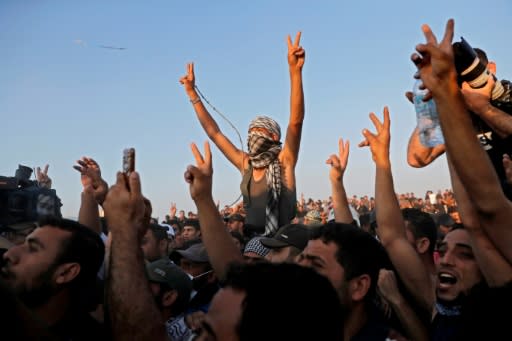 Supporters of Hamas leader Ismail Haniya react during his speech near the border with Israel east of Gaza City on May 15, 2018