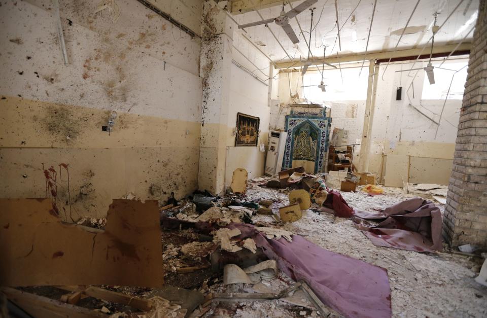 Debris lays strewn at the site of a bomb attack inside a Shi'ite mosque in Baghdad May 27, 2014. (REUTERS/Thaier Al-Sudani)