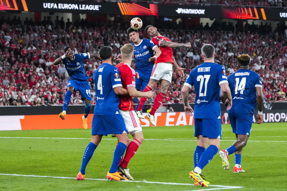 Marseille's Leonardo Balerdi, top left, goes for a header with Benfica's Nicolas Otamendi during the Europa League quarterfinals, first leg, soccer match between SL Benfica and Olympique de Marseille at the Luz stadium in Lisbon, Thursday, April 11, 2024. (AP Photo/Armando Franca)