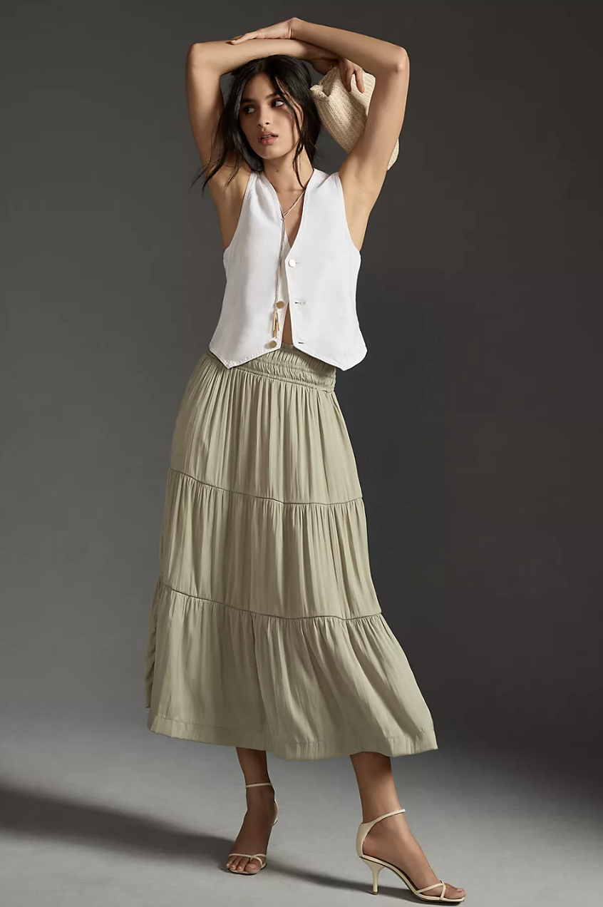 model in white vest, sandals and The Somerset Maxi Skirt in moss (photo via Anthropologie)