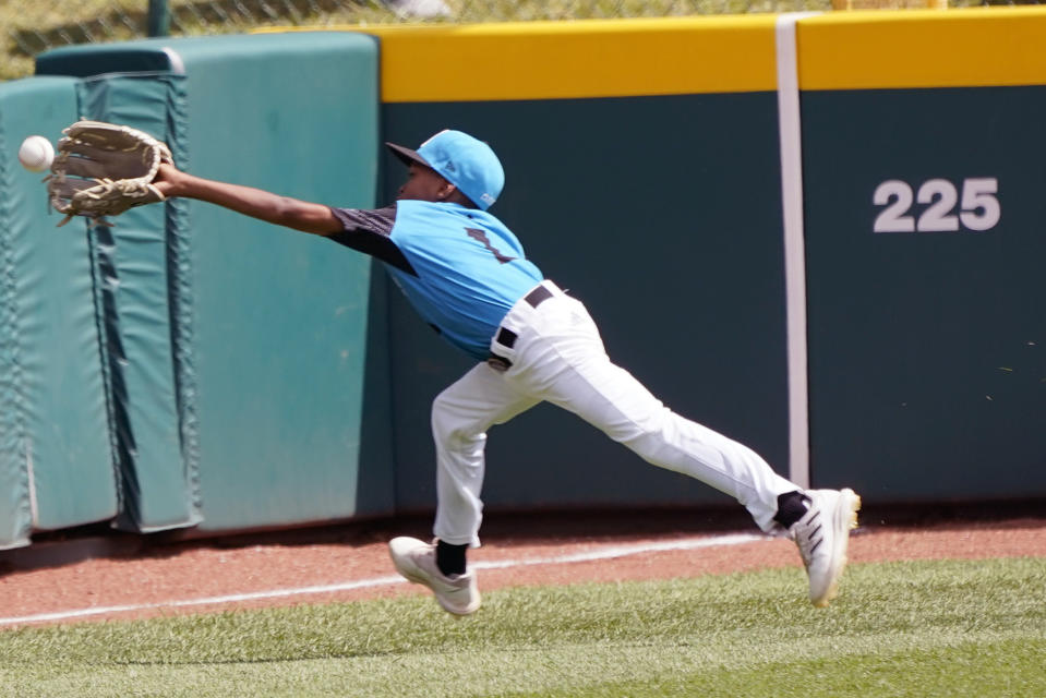 Curacao left fielder Jaythan Cordilia (1) makes a running catch on a ball hit by Taiwan's Shen Li-Chen during the fourth inning of the International Championship baseball game at the Little League World Series tournament in South Williamsport, Pa., Saturday, Aug. 27, 2022. Curacao won 1-0. (AP Photo/Tom E. Puskar)