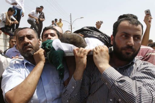 People carry the body of a four-year-old Syrian boy during his funeral in Jordanian town of Ramtha. Syrian rebels staved off a fightback by regime forces in Aleppo on Saturday amid growing concern about the risks of reprisals against civilians in the country's commercial capital