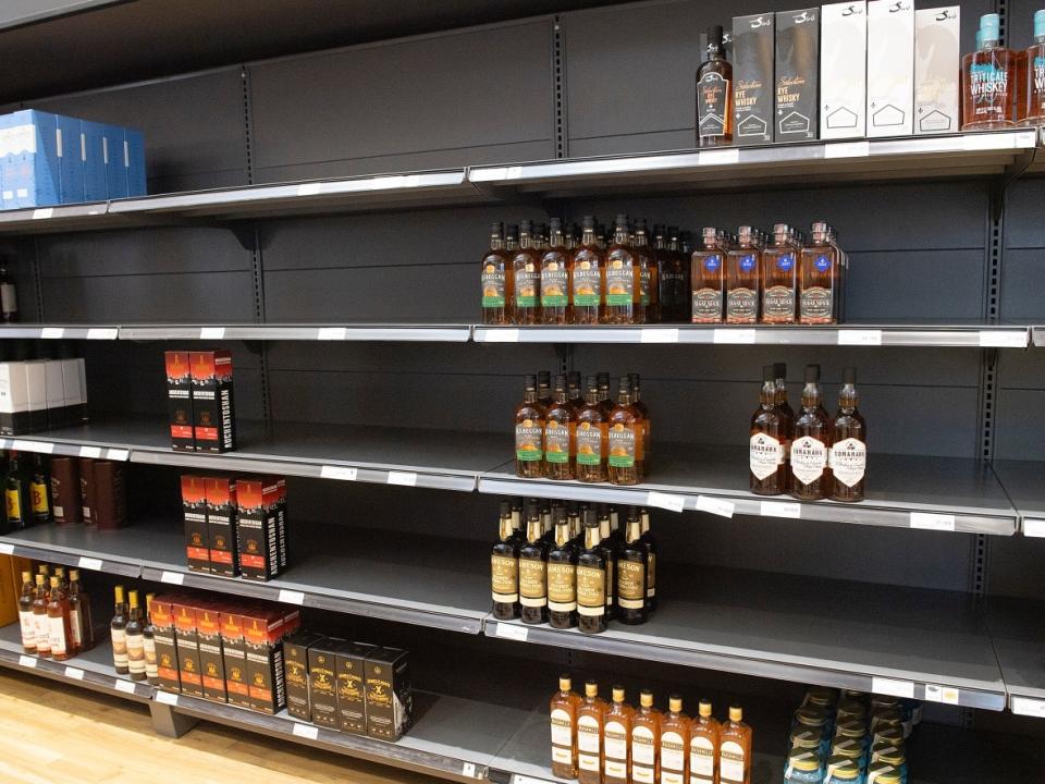 Shelves are bare on Tuesday at this SAQ outlet in Montreal. Catherine Dagenais, president and chief executive officer of the SAQ, says there will be holes in stock come Christmastime. (Graham Hughes/The Canadian Press - image credit)