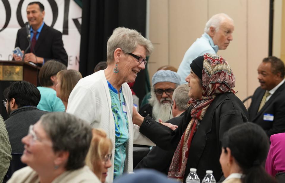 Mary Vulic, left, and Malika Haque share a moment during the Interfaith Iftar held Wednesday at the Noor Islamic Cultural Center. Vulic is a United Methodist Church member; Haque is a Muslim.