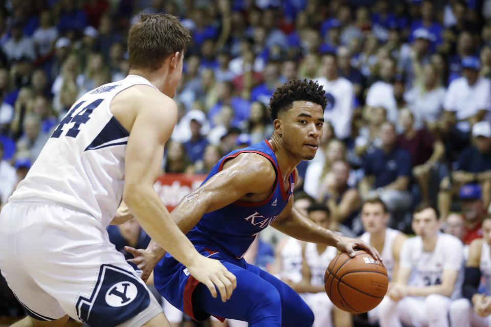 Kansas guard Devon Dotson (1) tries to get around BYU guard Connor Harding (44) on Nov. 26, 2019, in Lahaina, Hawaii. (AP Photo/Marco Garcia)