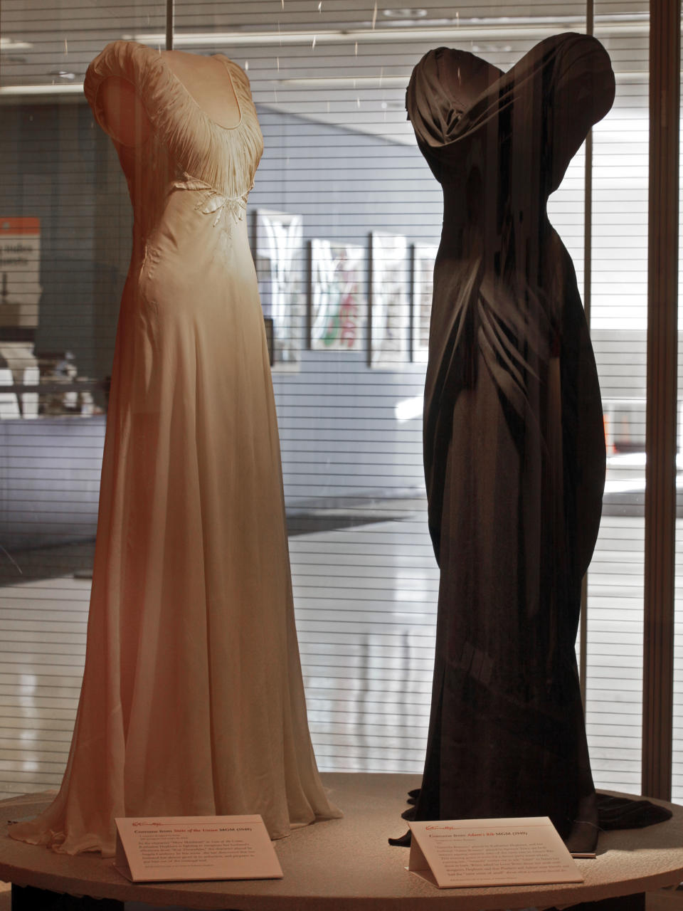 A design by Irene, left, from the 1948 MGM movie "State of the Union," and one by Walter Plunkett from the 1949 MGM movie "Adam's Rib," are shown as part of the "Katharine Hepburn: Dressed for Stage and Screen" exhibit in the New York Public Library for the Performing Arts at Lincoln Center, Tuesday, Oct. 16, 2012. (AP Photo/Richard Drew)