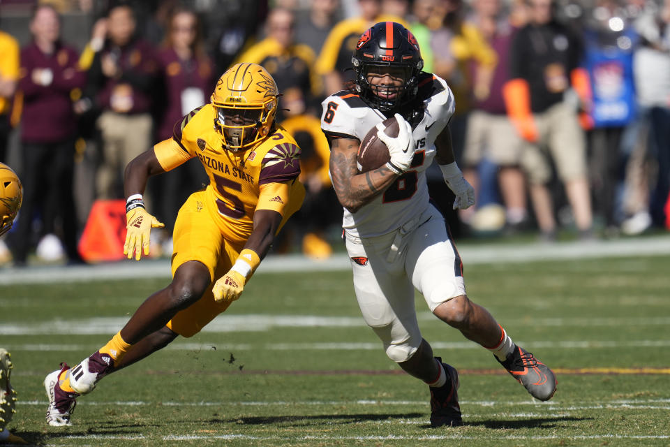 FILE - Oregon State running back Damien Martinez (6) runs past Arizona State defensive back Chris Edmonds (5) during the first half of an NCAA college football game in Tempe, Ariz., Saturday, Nov. 19, 2022. Oregon State opens their season at San Jose State on Sept. 3. (AP Photo/Ross D. Franklin, File)