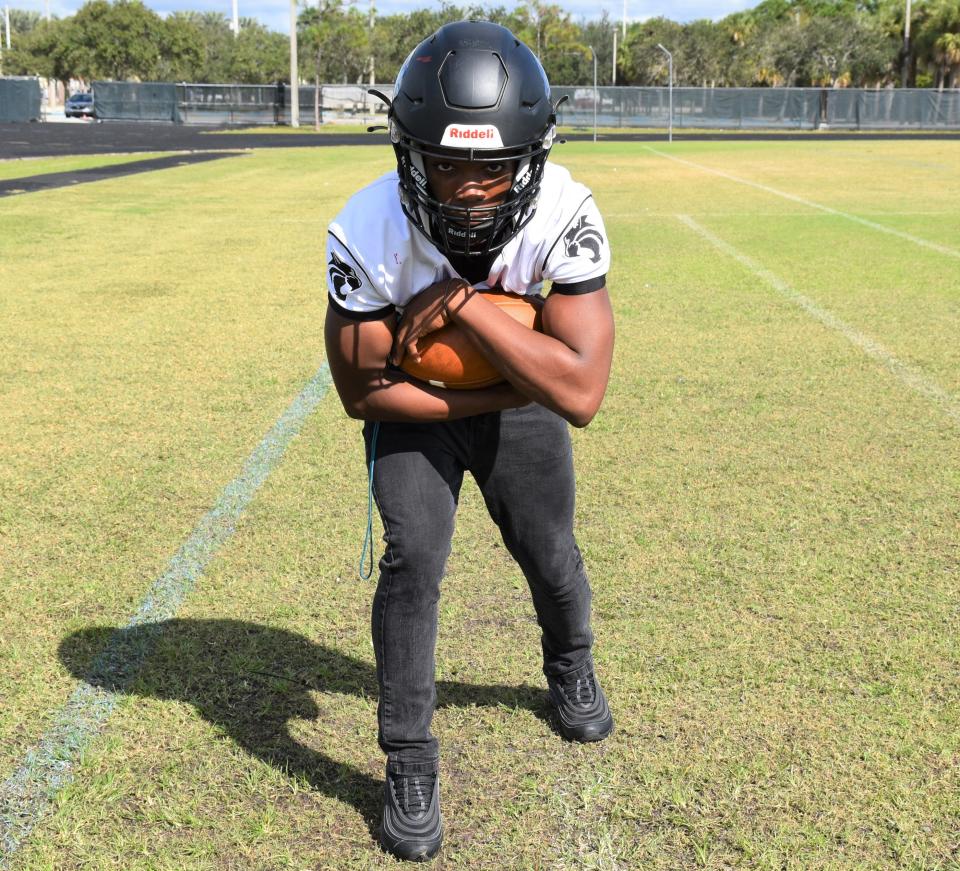 Royal Palm Beach's Garvan Dorival strikes a football pose as he is awarded Athlete of the Week recognition on the Wildcats' football field on Nov. 10, 2023.