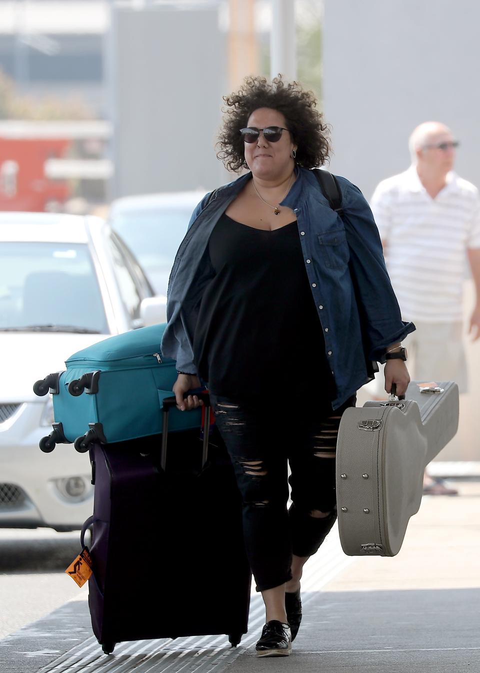 Casey could barely contain her grin as she entered the airport. Photo: DIIMEX.