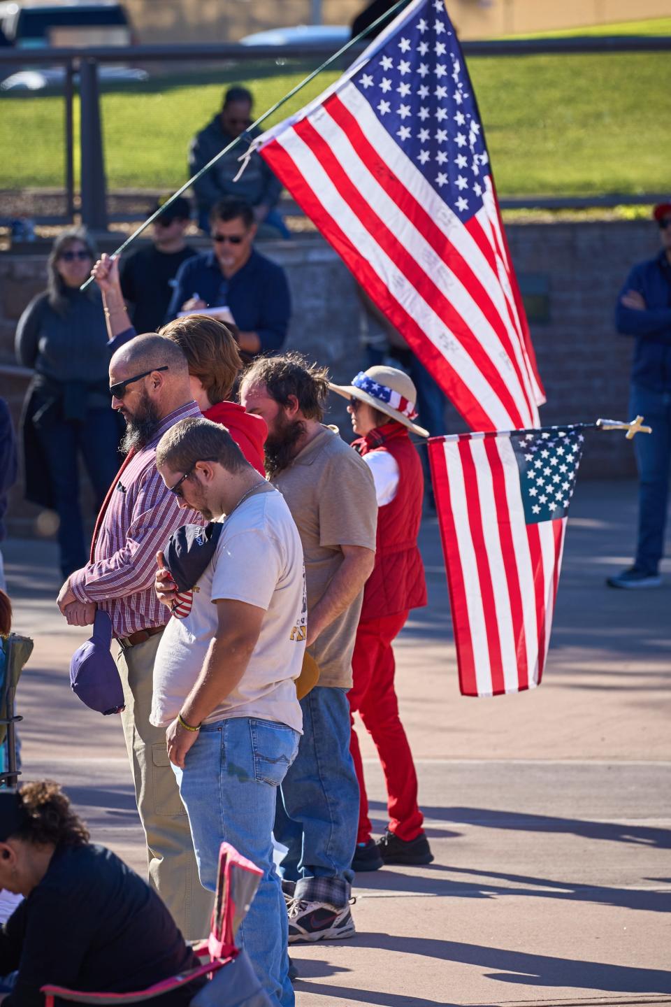 Demonstrators bow their heads in prayer while demanding a redo on the 2022 general election at Wesley Bolin Memorial Plaza in Phoenix on Friday, Nov 25, 2022.
(Photo: Alex Gould/The Republic)