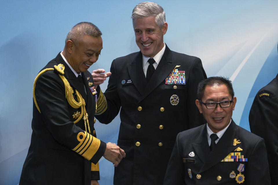 Steve Koehler, center, commander of the U.S. Pacific Fleet, reacts as he joins other attendees for a group photo before attending the Western Pacific Navy Symposium in Qingdao, eastern China's Shandong province on Monday, April 22, 2024. The meeting has drawn representatives from partners and competitors including Australia, Cambodia, Chile, France, India and the U.S. and comes amid heightened tensions over China's assertive actions in the Taiwan Strait and the East and South China seas, and as China's navy has grown into the world's largest by number of hulls. (AP Photo/Ng Han Guan)