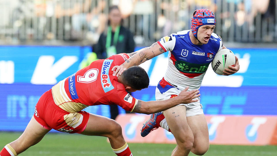 Seen here, Newcastle fullback Kalyn Ponga runs with the footy against the Dolphins in Perth. 